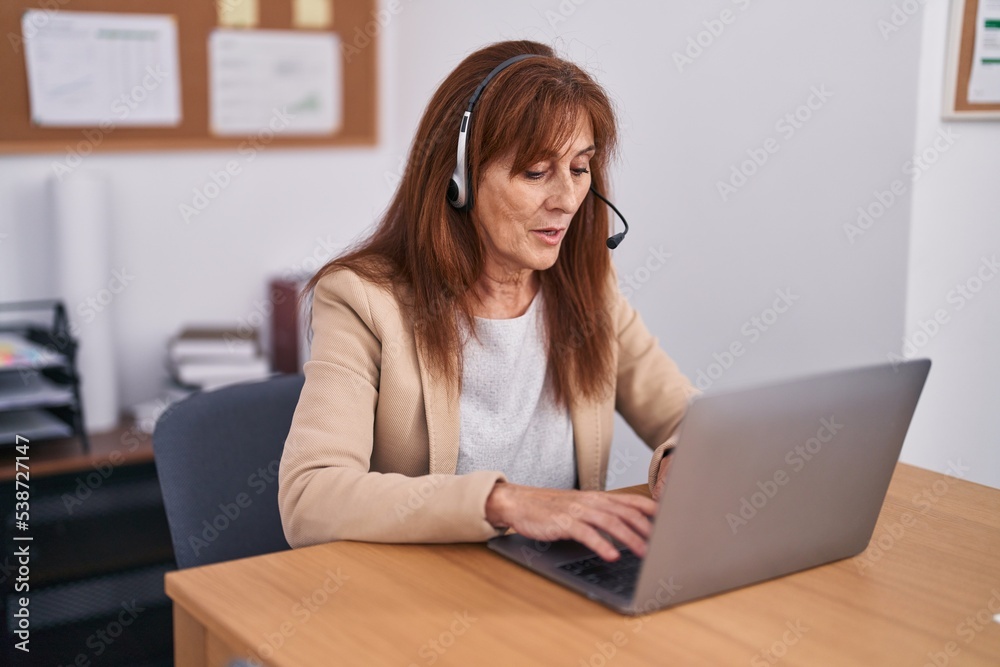 Middle age woman call center agent working at office Middle age woman call center agent working at office