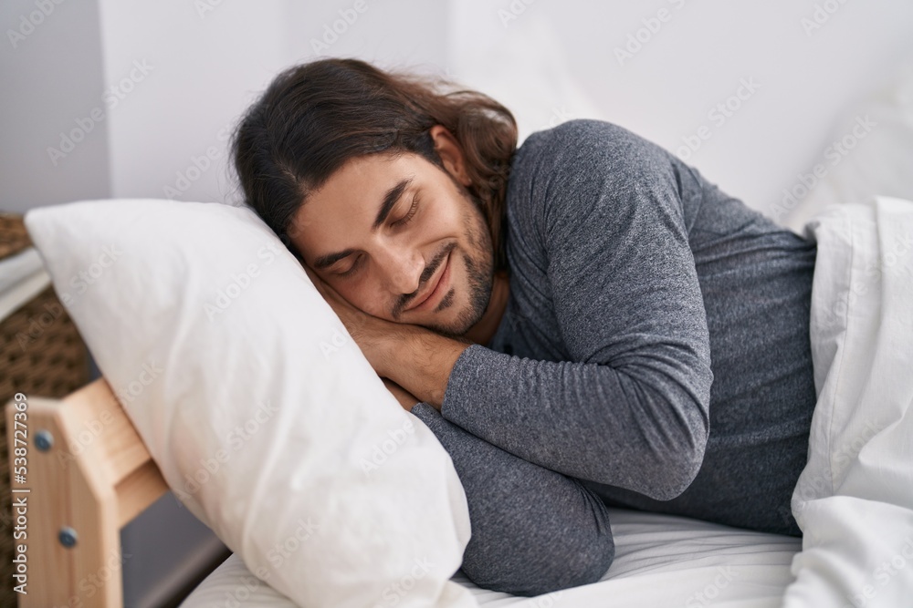 Young hispanic man lying on bed sleeping at bedroom Young hispanic man lying on bed sleeping at bedroom