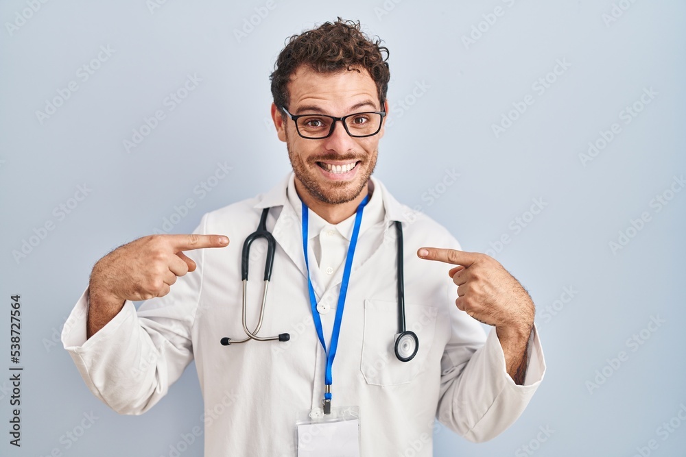 Young hispanic man wearing doctor uniform and stethoscope looking confident with smile on face, pointing oneself with fingers proud and happy. Young hispanic man wearing doctor uniform and stethoscope looking confident with smile on face, pointing oneself with fingers proud and happy.