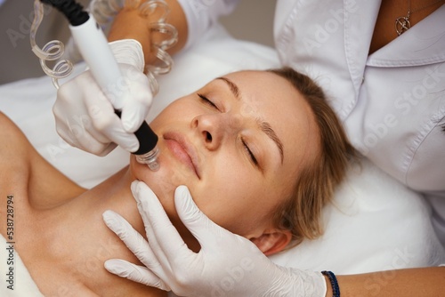 A cosmetologist performs hydropiling in a beauty salon. Skin care.
