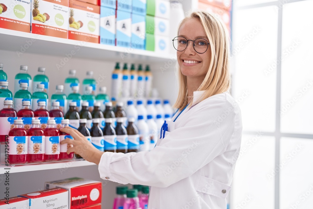 Young blonde woman pharmacist smiling confident working at pharmacy Young blonde woman pharmacist smiling confident working at pharmacy
