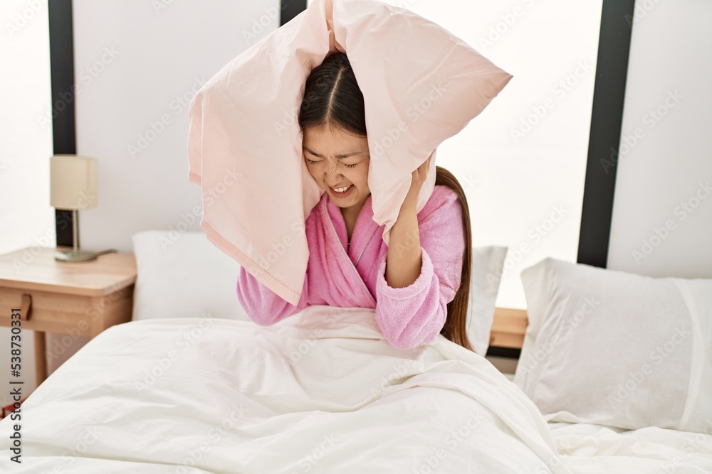 Young chinese girl smiling happy lying on the bed at bedroom. Young chinese girl smiling happy lying on the bed at bedroom.