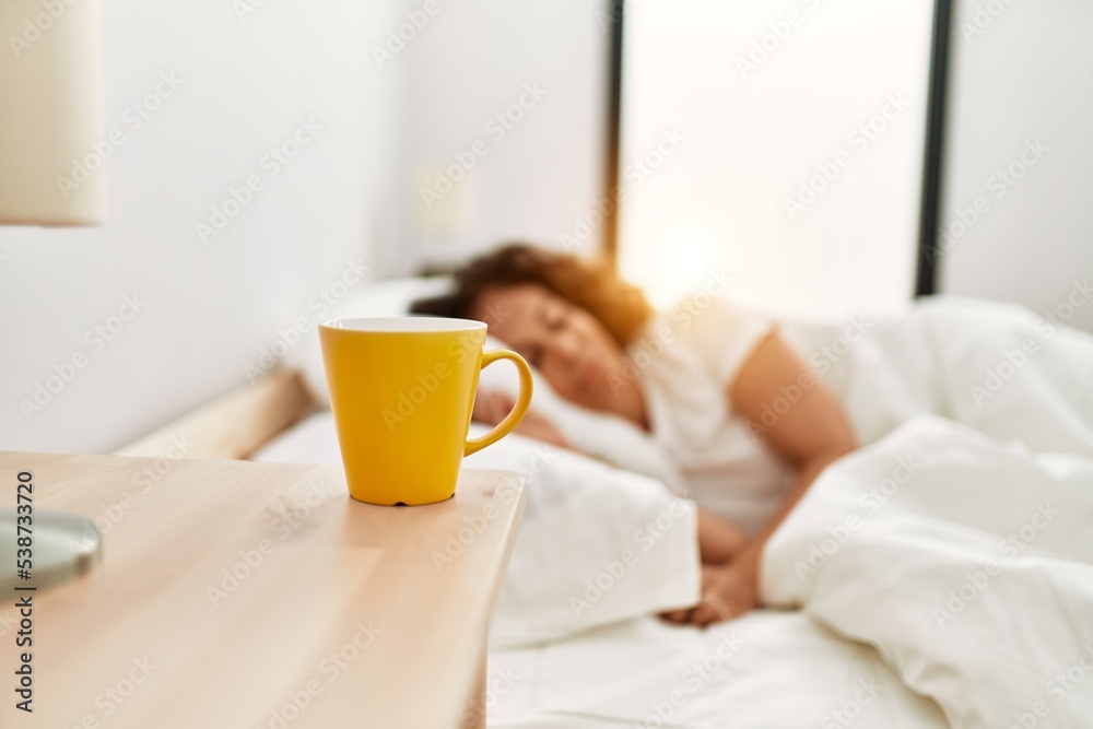 Middle age hispanic woman sleeping on the bed at bedroom