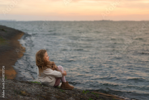 Young girl watching the see. photo