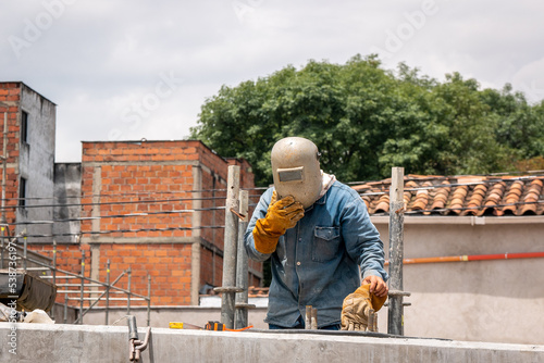 Worker Wearing a Welder's Mask on the Construction of the New Roadway