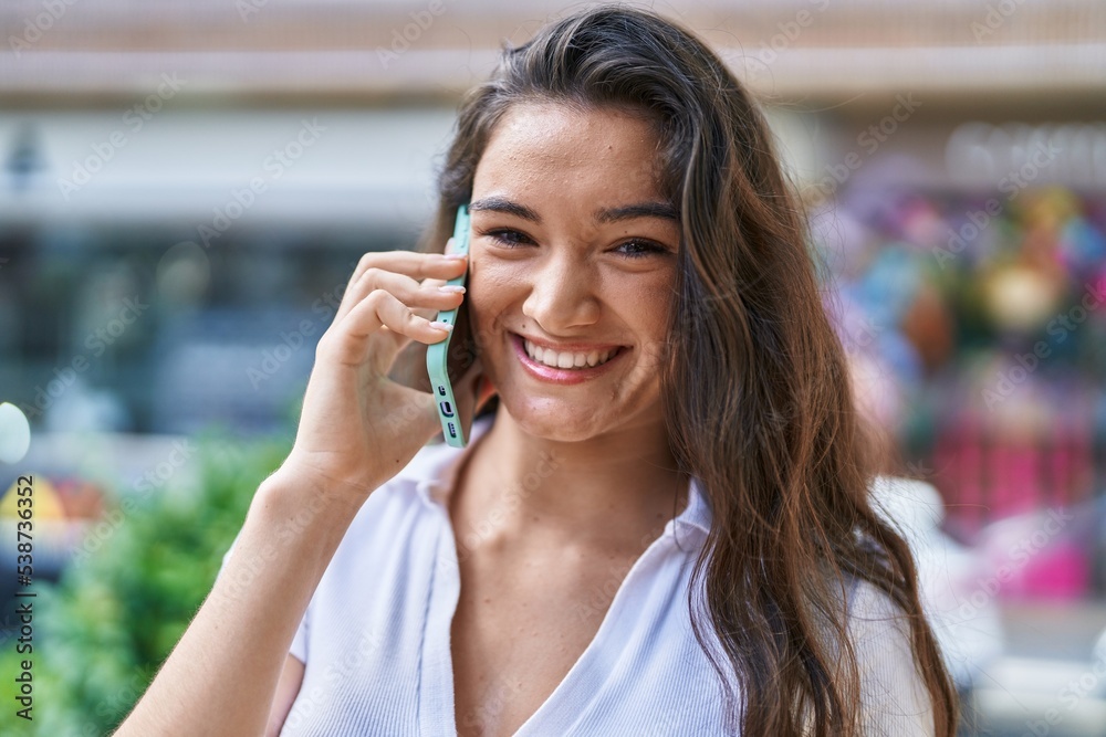 Young hispanic woman smiling confident talking on smartphone at street Young hispanic woman smiling confident talking on smartphone at street