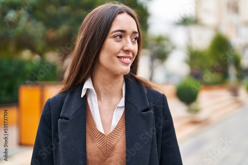 Young beautiful hispanic woman smiling confident looking to the side at park