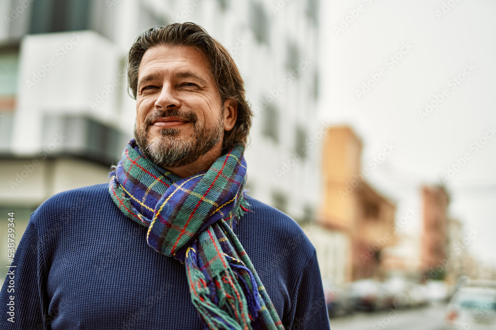 Middle age handsome man smiling at the town Middle age handsome man smiling at the town