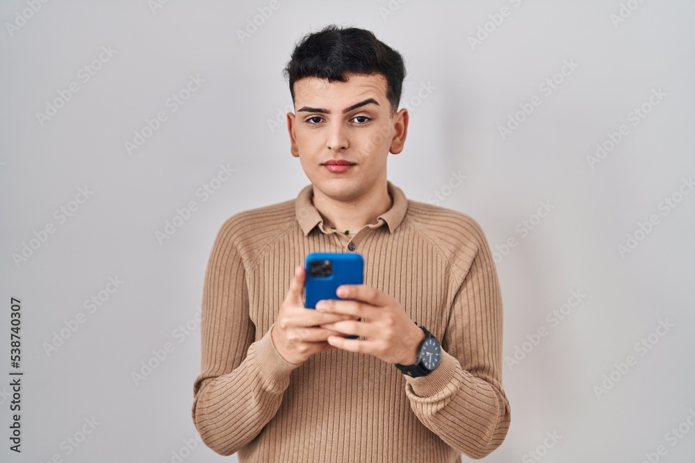 Non binary person using smartphone typing message skeptic and nervous, frowning upset because of problem. negative person. Non binary person using smartphone typing message skeptic and nervous, frowning upset because of problem. negative person.