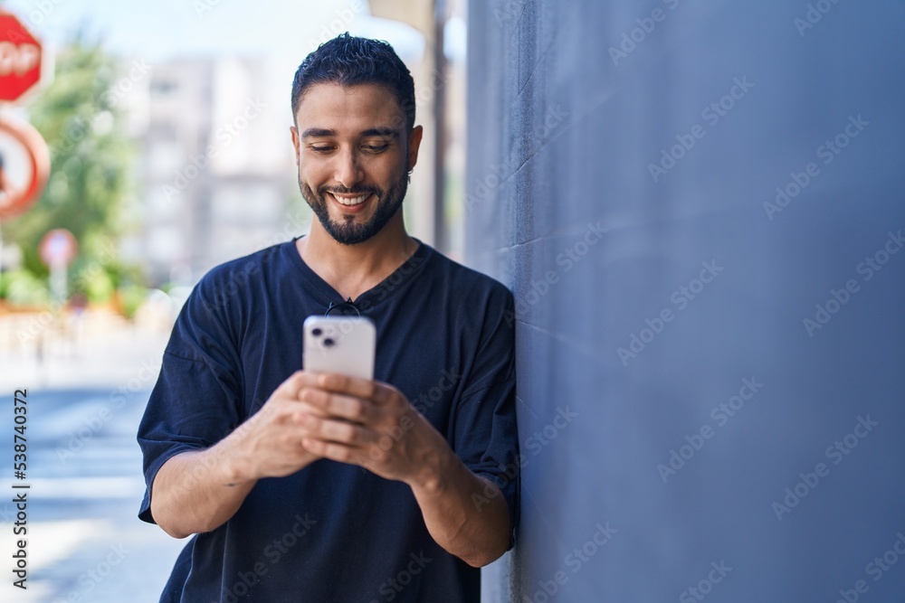 Young arab man smiling confident using smartphone at street Young arab man smiling confident using smartphone at street