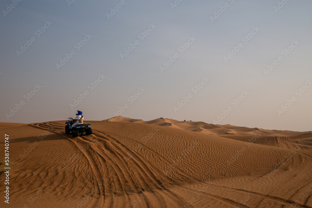 quad bike in sand dunes of desert quad bike in sand dunes of desert