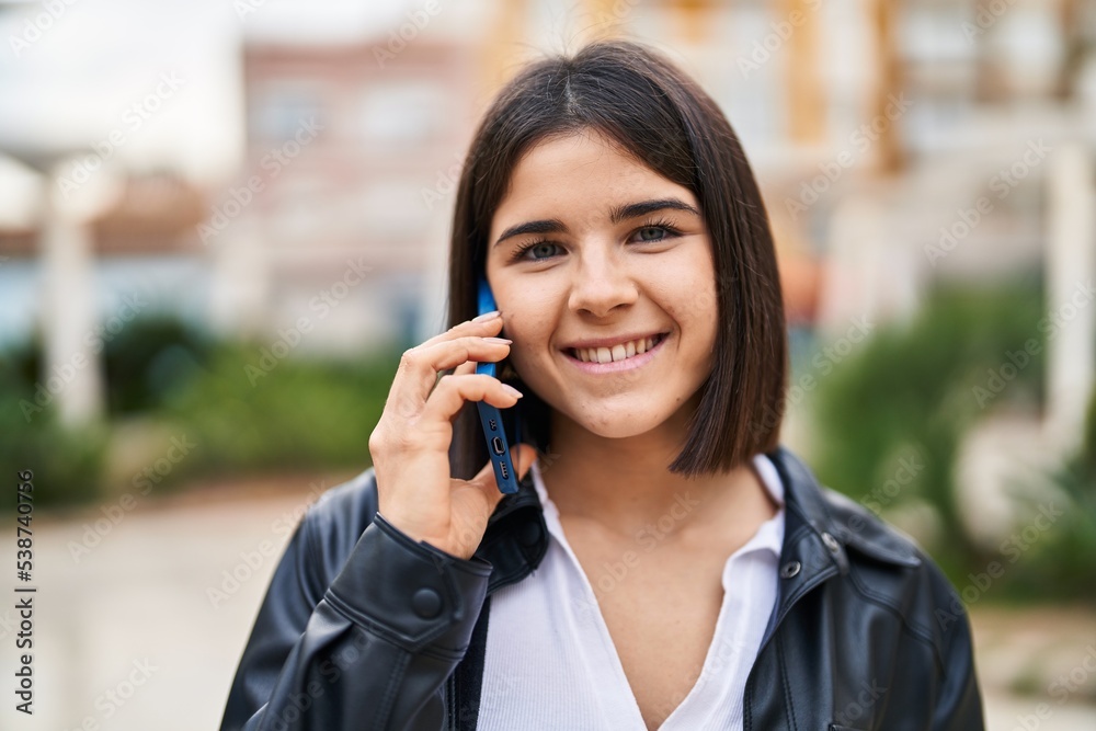 Young beautiful hispanic woman smiling confident talking on the smartphone at park Young beautiful hispanic woman smiling confident talking on the smartphone at park