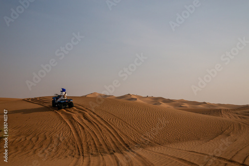 Photography quad bike in sand dunes of desert