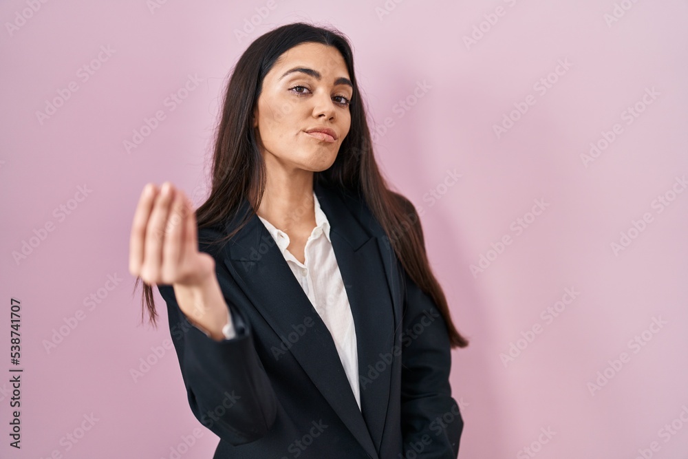 Young brunette woman wearing business style over pink background doing italian gesture with hand and fingers confident expression Young brunette woman wearing business style over pink background doing italian gesture with hand and fingers confident expression