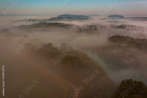 Misty Autumn Morning Sunrise Overlooking the Mighty Skagit River. Aerial drone view of the Skagit Valley and the iconic river that flows from the Cascade Mountains to the Puget Sound.