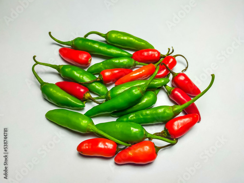 Mixed chilli pile isolated on a white background. Mixed chili background.