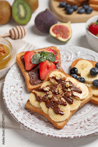 Different sweet delicious toasts on plate, closeup