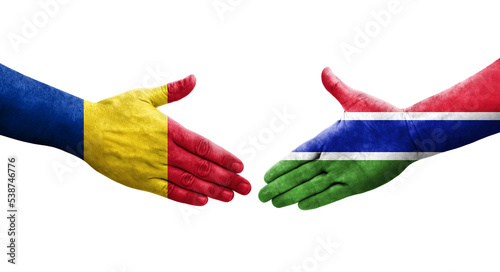 Handshake between Gambia and Romania flags painted on hands, isolated transparent image.