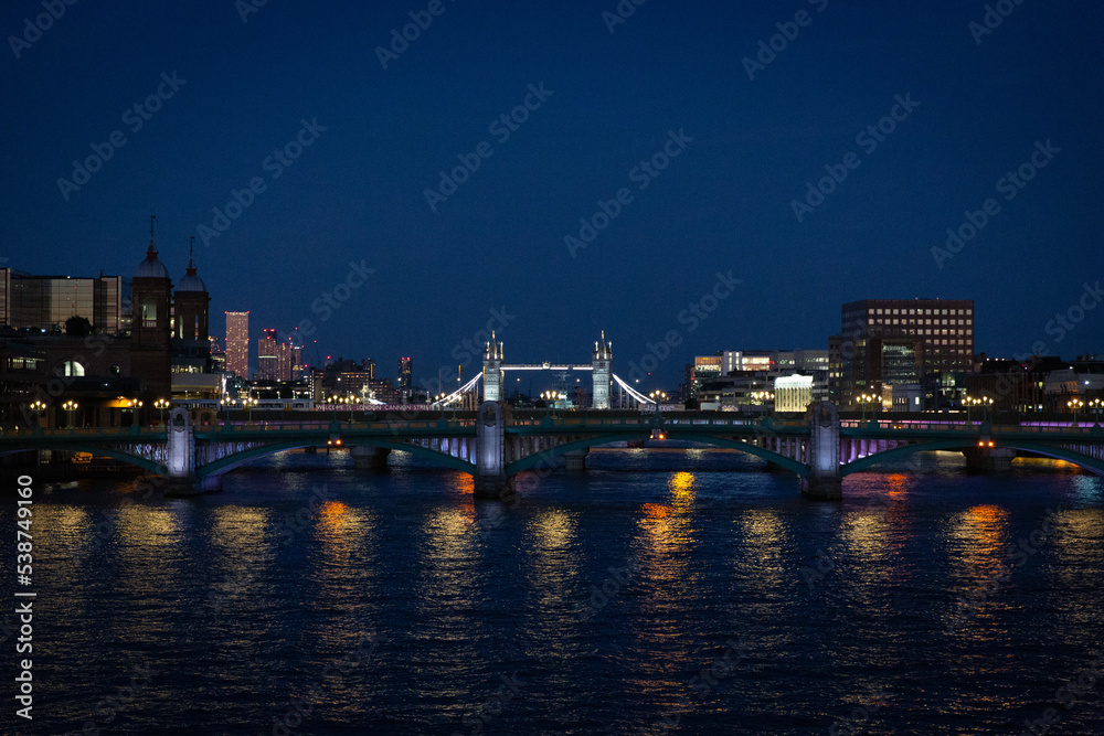 london bridge and skyline at sunset along the thames river