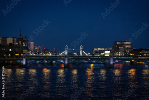 london bridge and skyline at sunset along the thames river