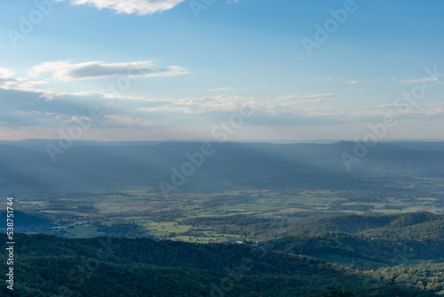 Sun rays shine down on rural Shenandoah Valley as seen from Skyline Drive in Shenandoah National Park, Virginia.