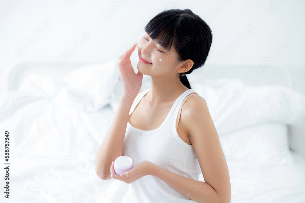 Beautiful young asian woman holding cartridge applying cream or lotion with moisturizer to skin on face, beauty asia girl applying skincare touch facial with cosmetic makeup, skin care concept. Beautiful young asian woman holding cartridge applying cream or lotion with moisturizer to skin on face, beauty asia girl applying skincare touch facial with cosmetic makeup, skin care concept.