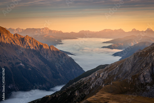 Misty valley from above Grossglockner and mountain landscape at dawn, Austria