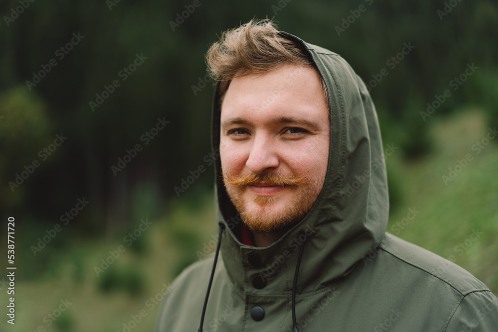 Portrait of Young happy male in the forest. Wellness concept and holistic rest. Portrait of a traveler Portrait of Young happy male in the forest. Wellness concept and holistic rest. Portrait of a traveler