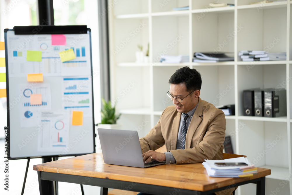 Handsome businessman working with laptop in office. Handsome businessman working with laptop in office.