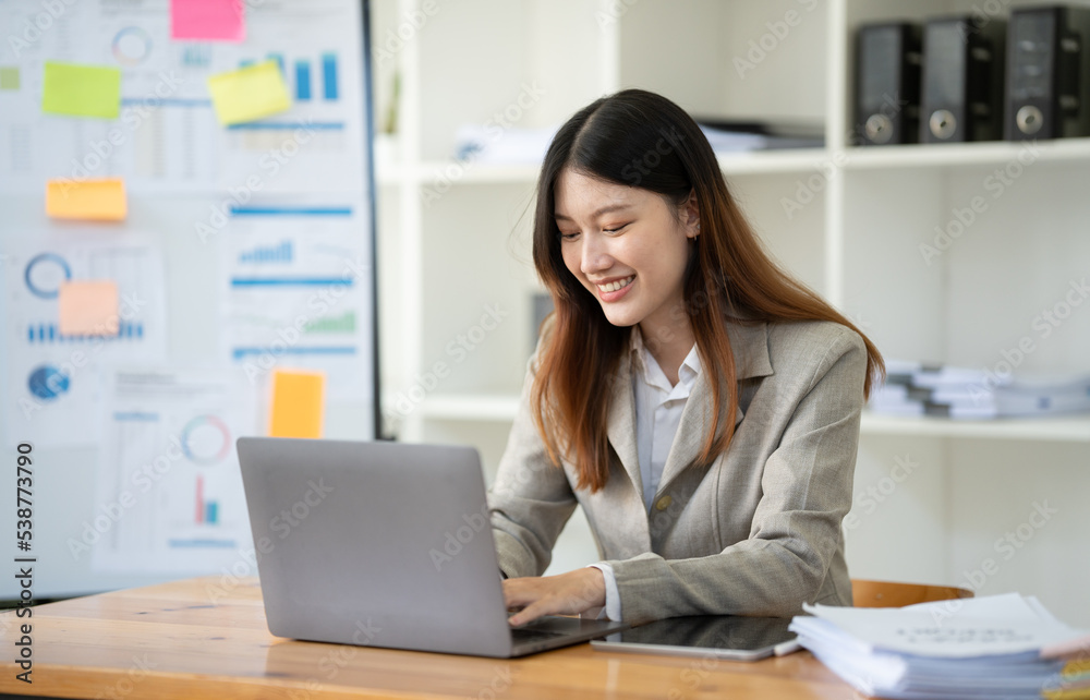 Portrait of businesswoman using laptop in office. Portrait of businesswoman using laptop in office.