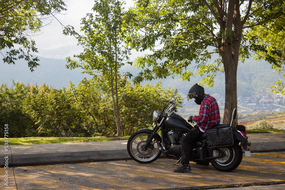 Casual man with helmet in his motorcycle on the street