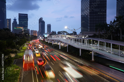 Jakarta, Indonesia: Traffic along the Sudirman avenue in Jakarta business and financial district at dusk captured with blurred motion in Indonesia capital city. photo
