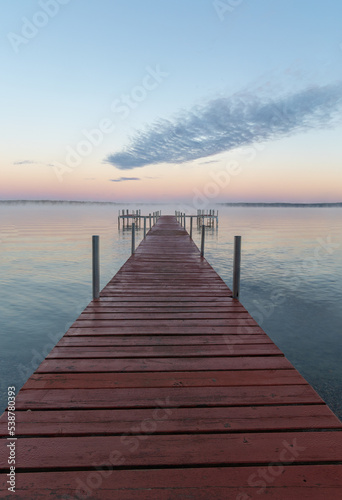 Dock on Mullett Lake in Indian River Michigan with pastel skies overhead © James
