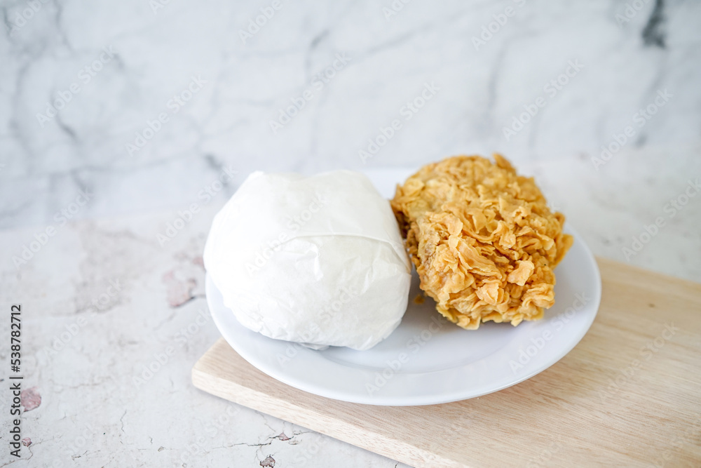 Fried chicken crisp with rice, fast food meal on a white plate Fried chicken crisp with rice, fast food meal on a white plate