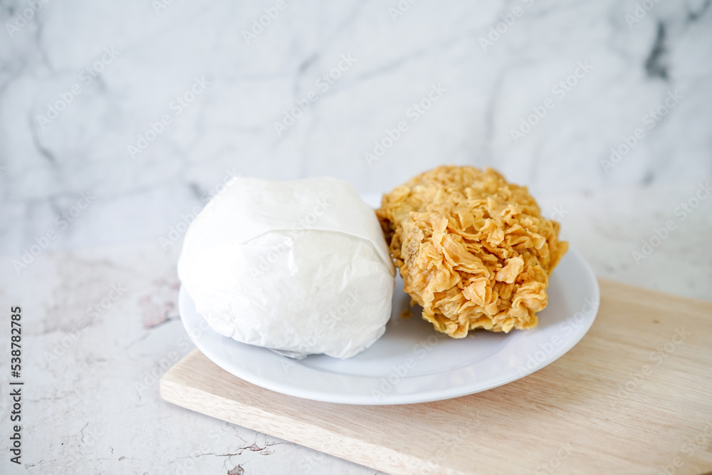 Fried chicken crisp with rice, fast food meal on a white plate Fried chicken crisp with rice, fast food meal on a white plate