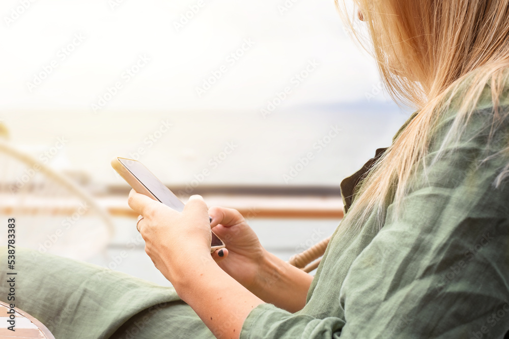 The girl uses the phone in a cafe The girl uses the phone in a cafe