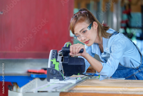 Wallpaper Mural Female Carpentry Student In Workshop Studying For Apprenticeship At College Using Bench Saw Torontodigital.ca