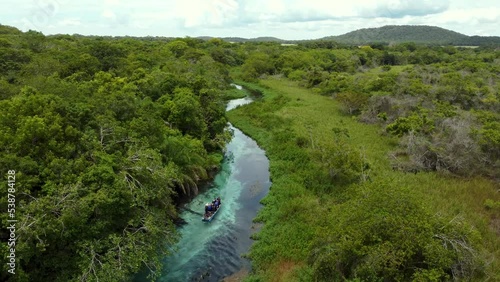 flying over a Boat in the crystalline water of Sucuri river - Bonito, Mato Grosso do Sul - Brazil photo
