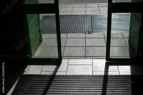 Shop doors open. Automatic doors in building. Transparent flaps.