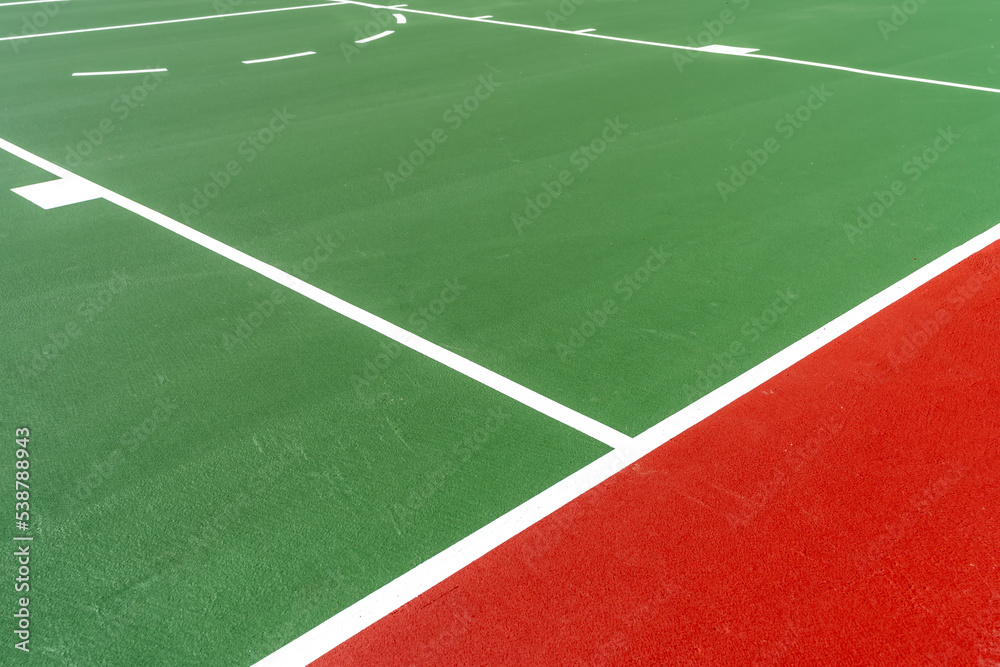 Interesting green and red outdoor basketball court at school playground.  