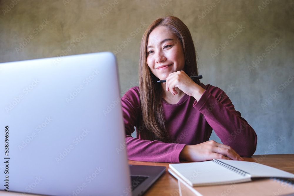 Portrait image of a business woman working on laptop computer Portrait image of a business woman working on laptop computer