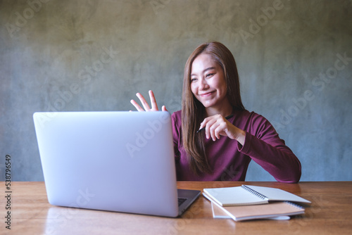 Portrait image of a beautiful young asian woman using laptop computer for video call, online meeting © Farknot Architect