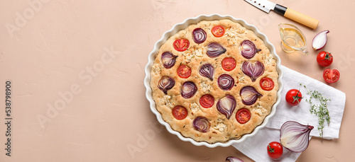 Fototapeta Naklejka Na Ścianę i Meble -  Composition with tasty Italian focaccia, oil and vegetables on beige background with space for text