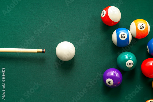 Valokuvatapetti Colorful billiard balls with cue on table