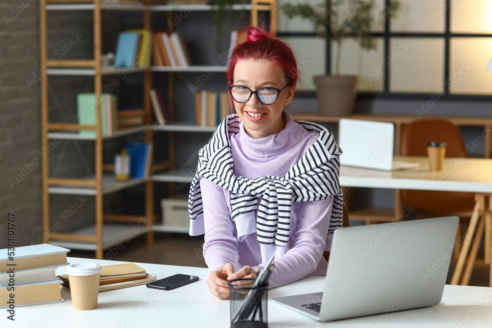 Young female student preparing for exam at home