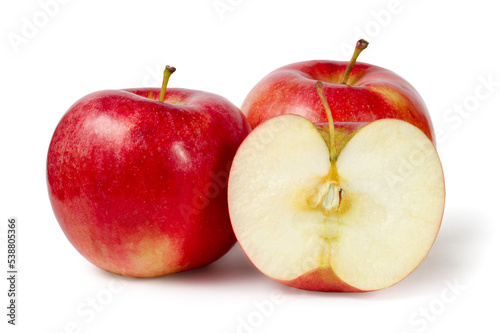 Red apples on a white background. In the foreground is half an apple.