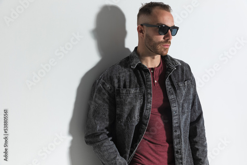 confident casual man with sunglasses holding hand in pocket