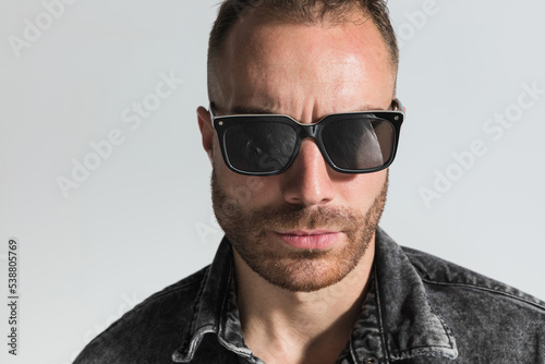 close up picture of handsome bearded man wearing sunglasses