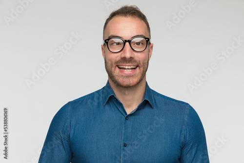 young casual man is crossing eyes, smiling photo
