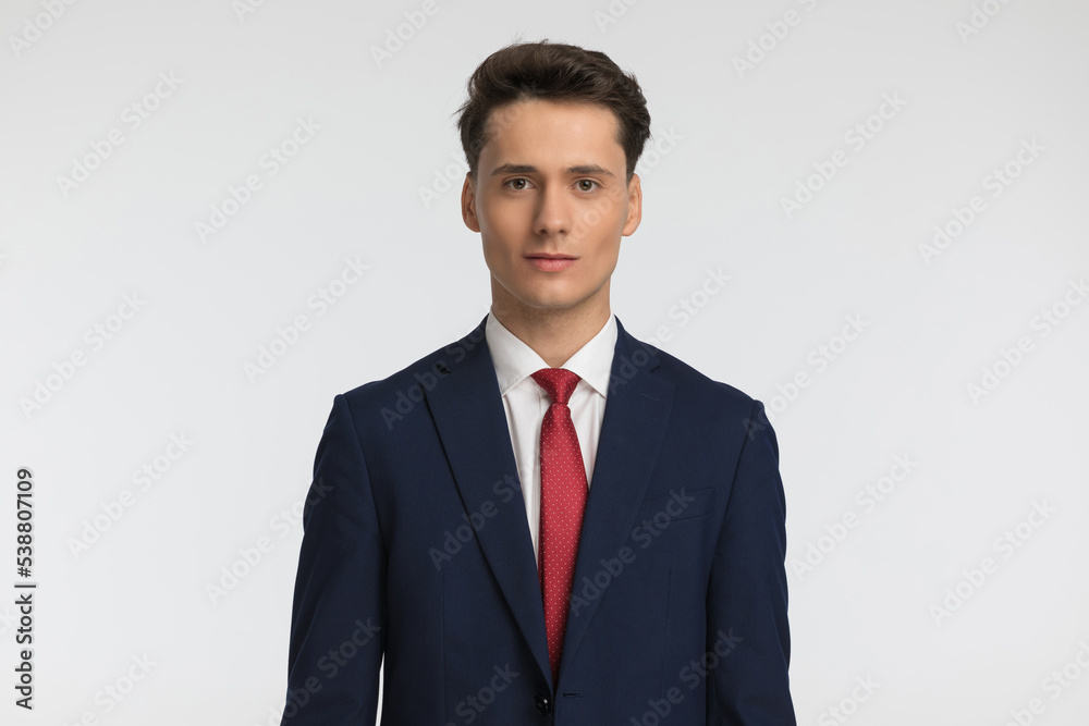 portrait of attractive young businessman wearing navy blue suit portrait of attractive young businessman wearing navy blue suit